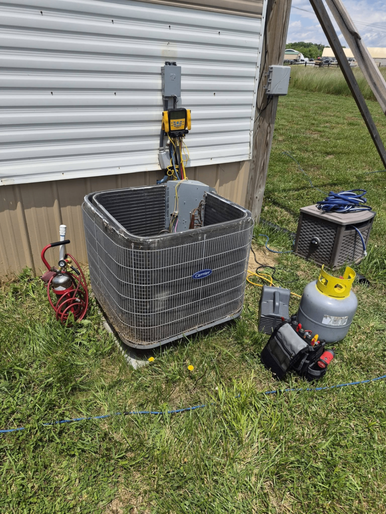 Carrier outdoor condenser with service setup beside a home